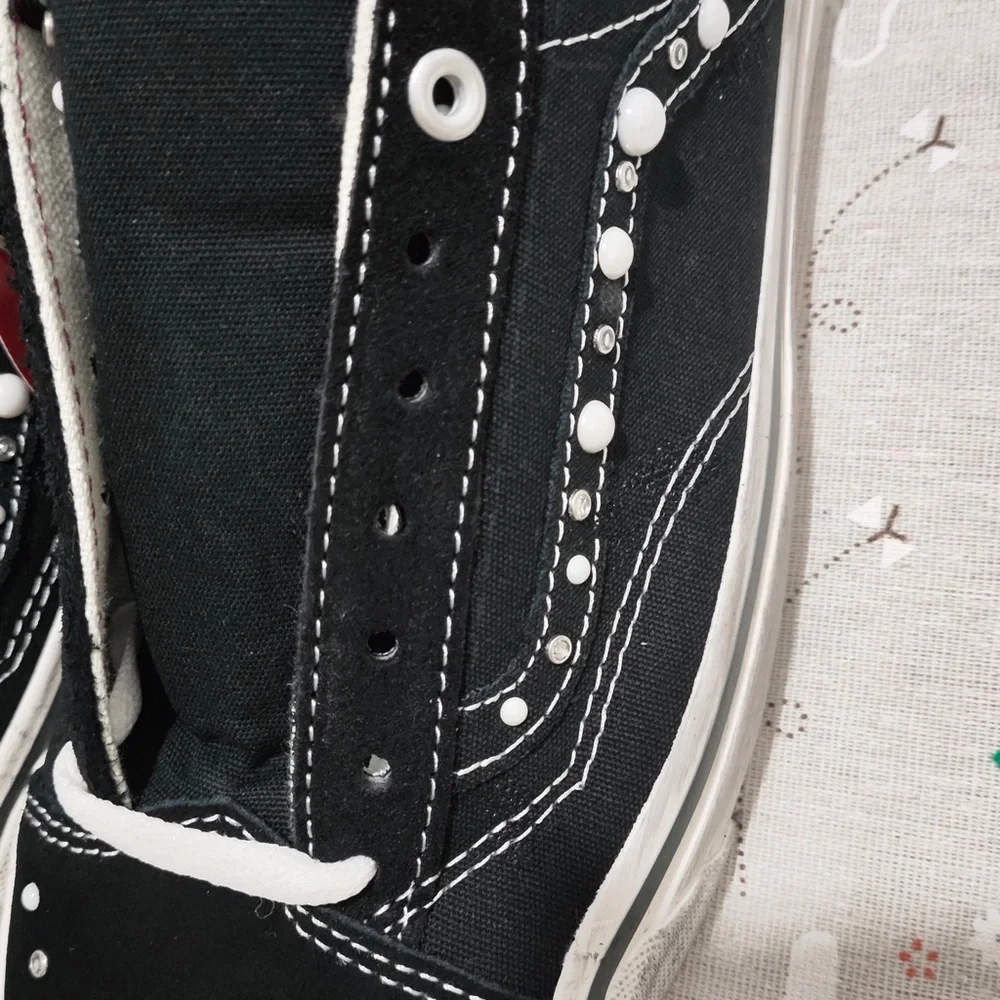 Vans Black Canvas Slip-On Sneakers with Maroon Lining and White Stud Detail